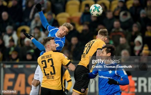 Florian Ballas and Marcel Franke of Dresden are challenged by Ji Dong-won and Felix Platte of Darmstadt during the Second Bundesliga match between SG...