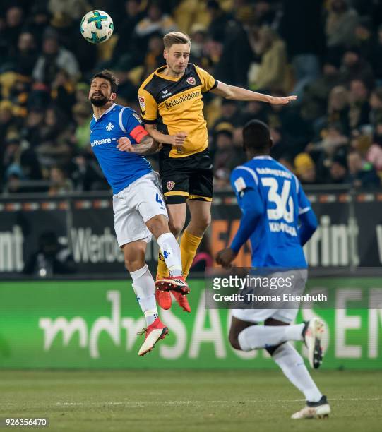 Lucas Roeser of Dresden is challenged by Aytac Sulu of Darmstadt during the Second Bundesliga match between SG Dynamo Dresden and SV Darmstadt 98 at...
