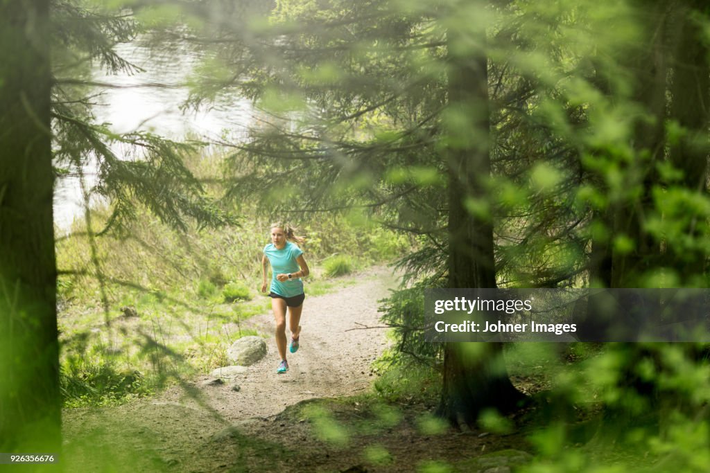 Woman running in forest