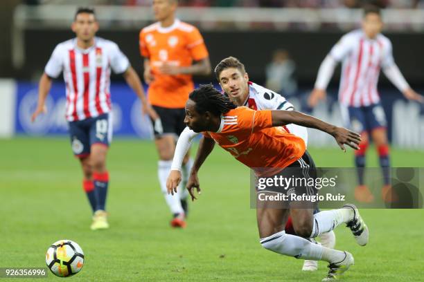 Isaac Brizuela of Chivas fights for the ball with Wilguens Aristide of Cibao during the match between Chivas and Cibao as part of the round of 16th...