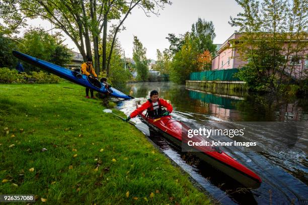 women putting kayaks on water - göteborg stad bildbanksfoton och bilder