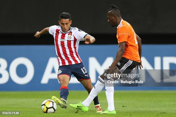 Walter Sandoval of Chivas fights for the ball with Tafarel Ferreira of Cibao during the match between Chivas and Cibao as part of the round of 16th...