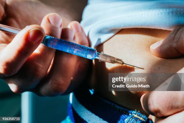 woman taking an injection at home. - insulin bildbanksfoton och bilder
