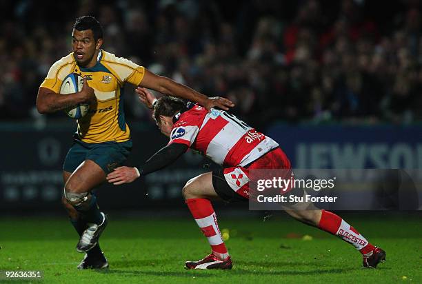 Australian full back Kurtley Beale races past Gloucester centre Henry Trinder during the match between Gloucester and Australia XV at Kingsholm on...