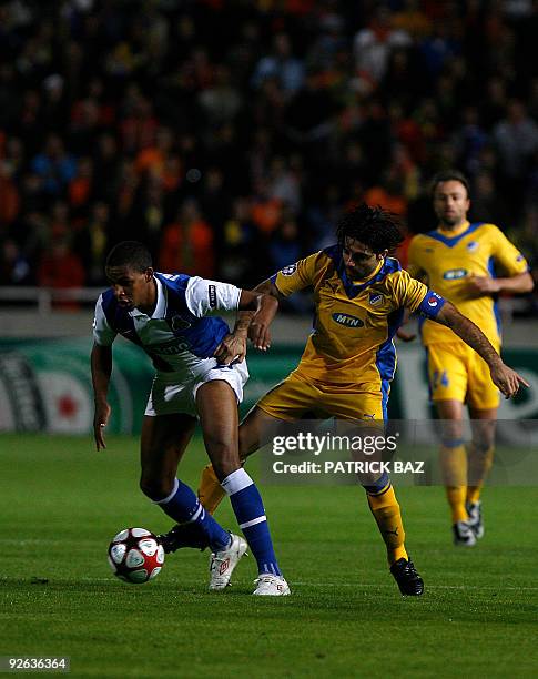 Apoel Nicosia's Marinos Satsias tries to intercept FC Porto's Fernando as he advances with the ball during their UEFA Champions League group D...