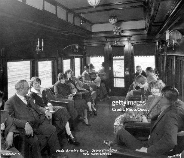 View of passengers in the 'Men's Smoking Room Observation Car' of the C&A railway's flagship service, 1925. The service ran between Chicago and St...