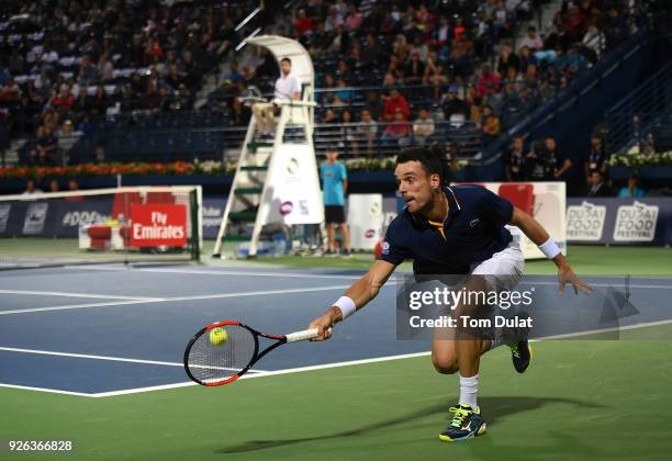 Roberto Bautista Agut of Spain plays a backhand during his semi final match against Malek Jaziri of Tunisia on day five of the ATP Dubai Duty Free...