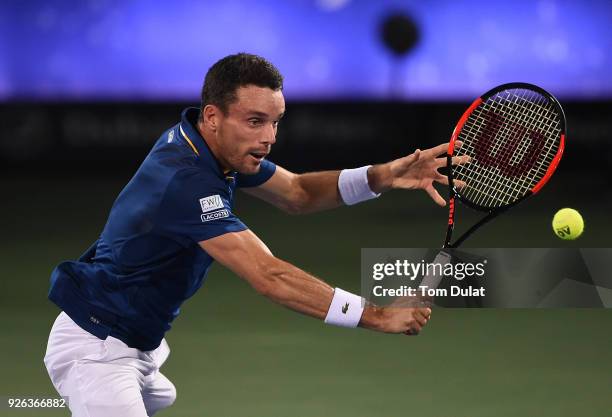 Roberto Bautista Agut of Spain plays a backhand during his semi final match against Malek Jaziri of Tunisia on day five of the ATP Dubai Duty Free...