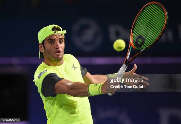 Malek Jaziri of Tunisia plays a backhand during his semi final match against Roberto Bautista Agut of Spain on day five of the ATP Dubai Duty Free...