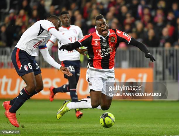 Nice's Italian forward Mario Balotelli is tackled by Lille's French midefielder Ibrahim Amadou during the French L1 football match Nice vs Lille on...