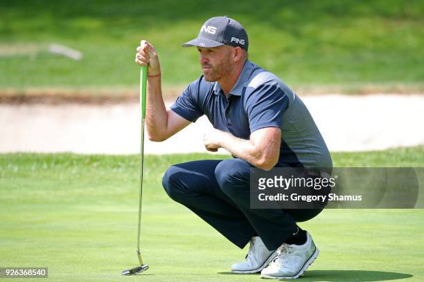 Adam Bland lines up a putt on the first green during the second round of World Golf Championships-Mexico Championship at Club de Golf Chapultepec on...