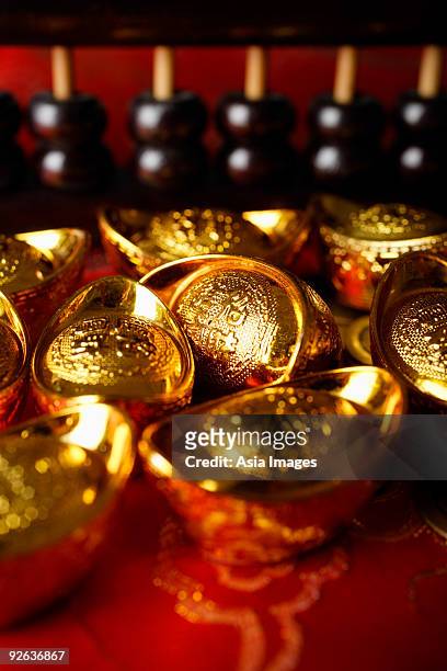 close up of gold ingots and abacus. - gold abacus stock pictures, royalty-free photos & images