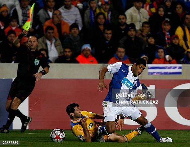 Apoel Nicosia's Marios Elia commits a foul on FC Porto's Hulk during their UEFA Champions League group D football match at the GSP Stadium in Nicosia...