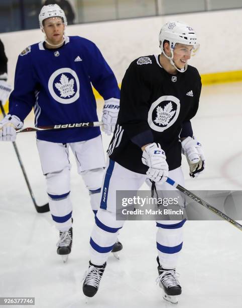 Travis Dermott and Connor Brown of the Toronto Maple Leafs skate during practice a day before their outdoor NHL Stadium Series Game against the...