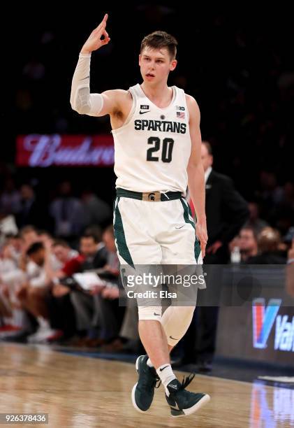 Matt McQuaid of the Michigan State Spartans celebrates his three point shot that helped cement the win over the Wisconsin Badgers during...