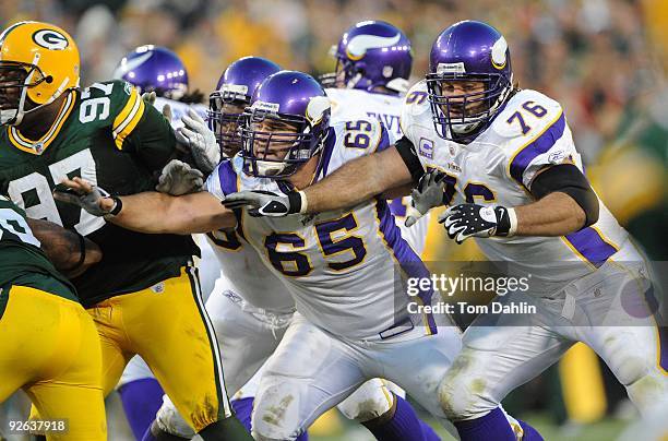 John Sullivan and Steve Hutchinson of the Minnesota Vikings pass blocks during an NFL game against the Green Bay Packers at Lambeau Field on November...