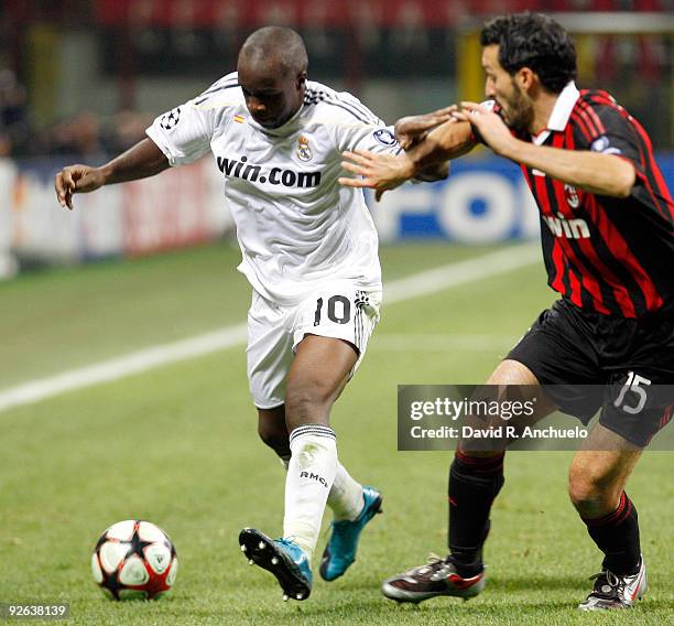 Lassana Diarra of Real Madrid fights for the ball with Gianluca Zambrotta during the UEFA Champions League Group C match between Real Madrid and...