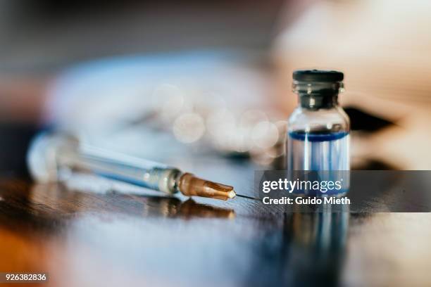 syringe and a vial. - injection stock pictures, royalty-free photos & images