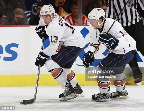 Robert Nilsson of the Edmonton Oilers looks on as teammate Andrew Cogliano skates up ice with the puck during their game against the Vancouver...