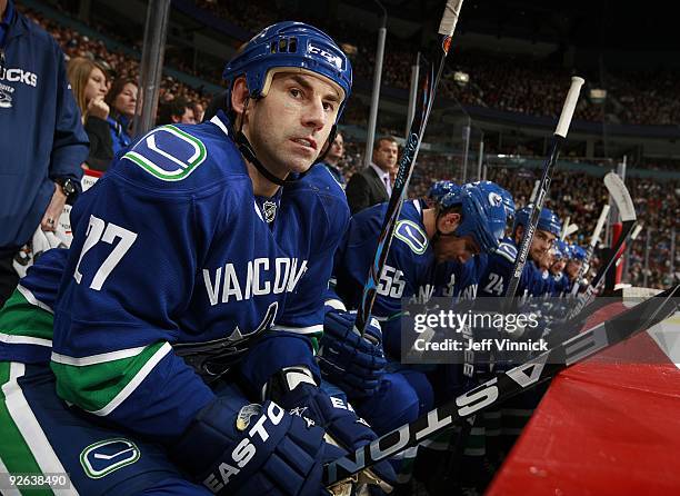 Mathieu Schneider of the Vancouver Canucks looks on from the bench during their game against the Edmonton Oilers at General Motors Place on October...