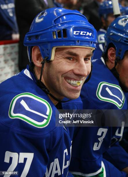 Mathieu Schneider of the Vancouver Canucks looks on from the bench during their game against the Edmonton Oilers at General Motors Place on October...