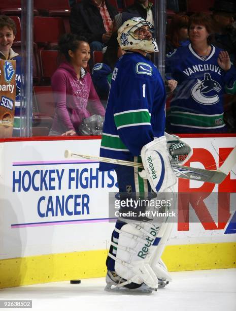 Roberto Luongo of the Vancouver Canucks stands by a Hockey Fights Cancer sign during their game against the Edmonton Oilers at General Motors Place...