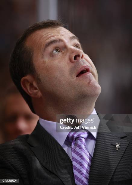 Head coach Alain Vigneault of the Vancouver Canucks looks on from the bench during their game against the Edmonton Oilers at General Motors Place on...