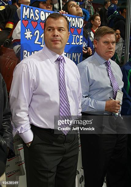 Head coach Alain Vigneault and assistant coach Ryan Walter of the Vancouver Canucks look on from the bench during their game against the Edmonton...