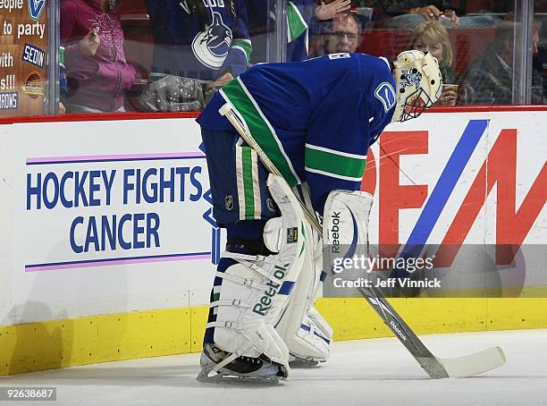 Roberto Luongo of the Vancouver Canucks stands by a Hockey Fights Cancer sign during their game against the Edmonton Oilers at General Motors Place...