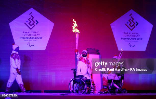 Ali Jawad lights the Paralympic flame watched by Sophie Christiansen CBE during the Paralympic Heritage Flame Lighting Ceremony ahead of the...