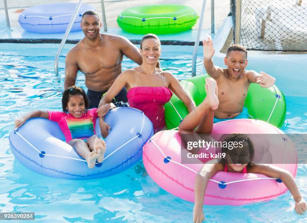 family having fun at water park lazy river - lazy river stock pictures, royalty-free photos & images