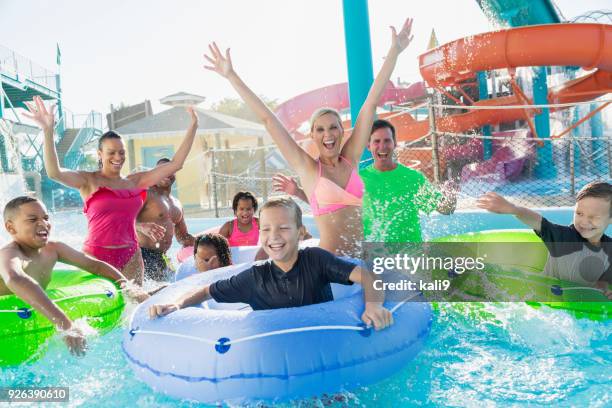 families and friends at water park on lazy river - lazy river stock pictures, royalty-free photos & images