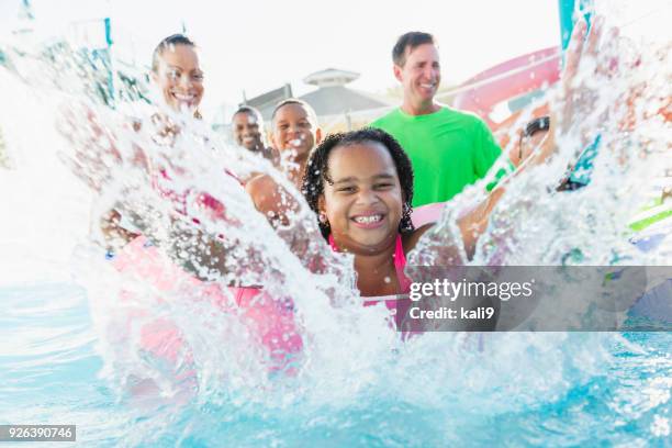 girl having fun at water park with family and friends. - boy river looking at camera stock pictures, royalty-free photos & images