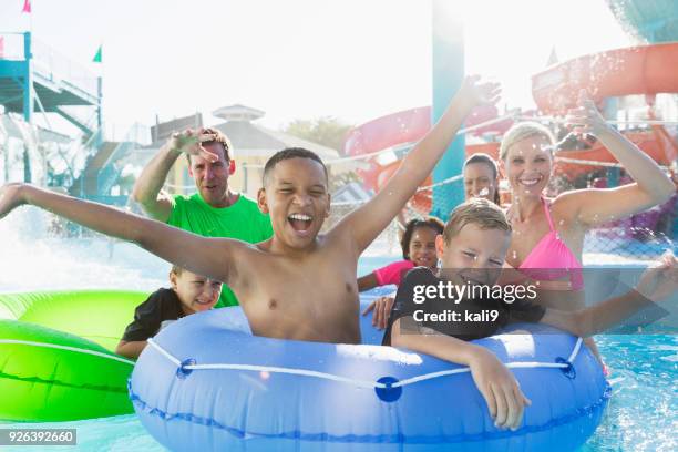 family and friends having fun at water park - lazy river stock pictures, royalty-free photos & images
