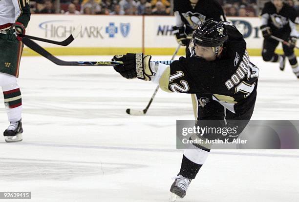 Chris Bourque of the Pittsburgh Penguins follows through on a shot against the Minnesota Wild at Mellon Arena on October 31, 2009 in Pittsburgh,...