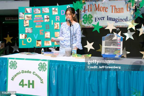 Student talks about lovebirds at the 4-H Club public speaking competition at Miami-Dade County Fair.