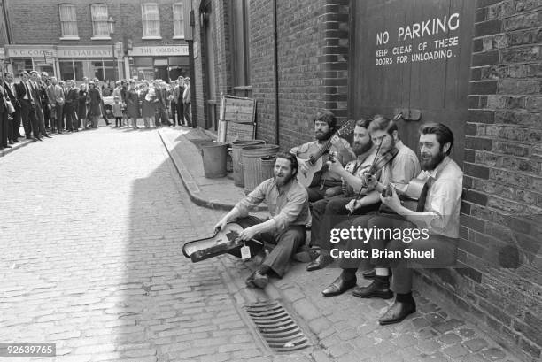 Photo of DUBLINERS; Group portrait at the back of Transatlantic Records in Marylebone, being watched by the public L-R Ciaran Bourke, Bob Lynch,...