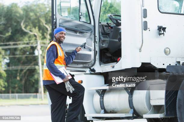 semi-truck driver climbing into cab - vehicle door stock pictures, royalty-free photos & images