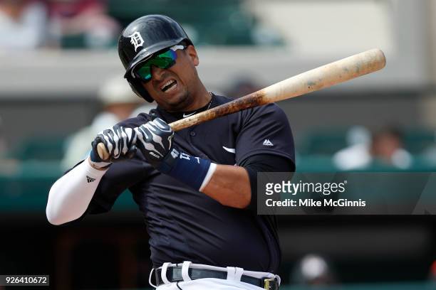 Victor Martinez of the Detroit Tigers gets crossed up by a pitch during the second inning of the Spring Training game against the Miami Marlins at...