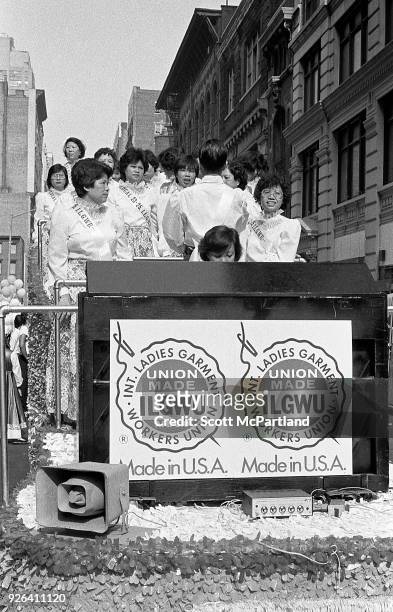 New York - Laborers in the Ladies Garment Workers Union stand on a float and protest on the streets of Chinatown. They are protesting the increased...