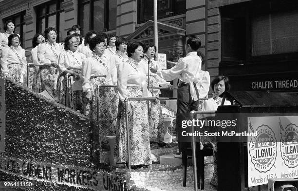 New York - Laborers in the Ladies Garment Workers Union stand on a float and sing protest songs on the streets of Chinatown. They are protesting the...