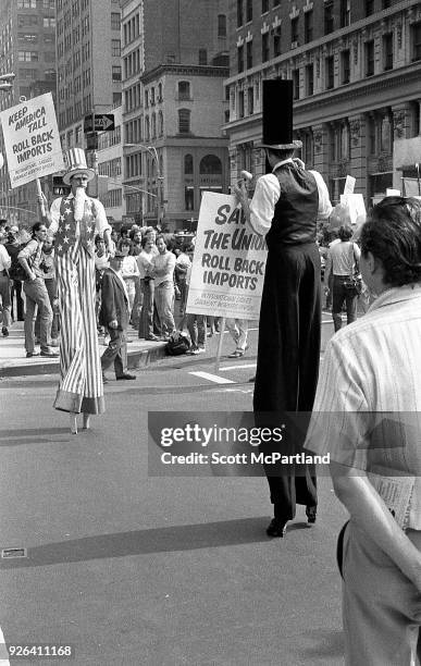 New York - Protesters on stilts stand on Broadway during an International Ladies Garment Workers Union rally. They are protesting the increased...