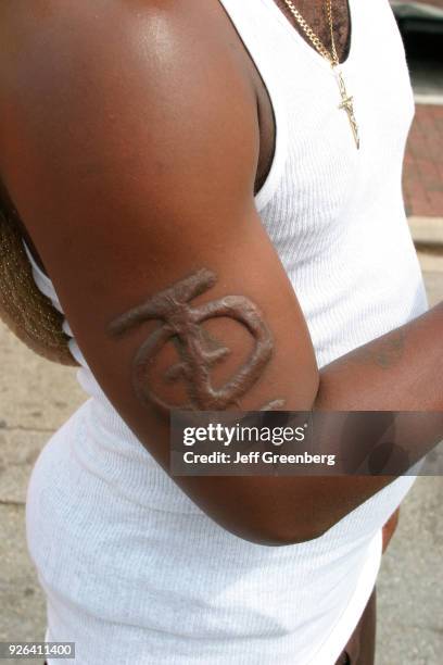 An arm branded with a fraternity symbol.