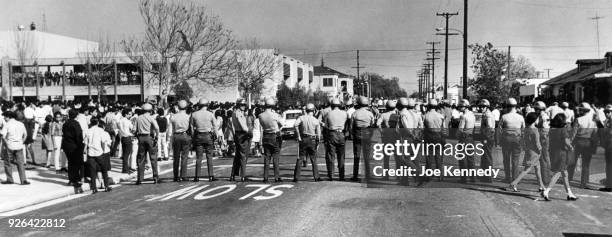 Image published on March 17, 1968--Sheriff's deputies form a line across street at Garfield High School during a student demonstration on March 5,...