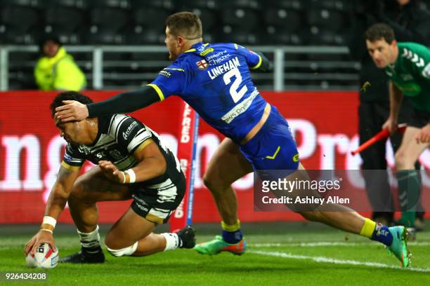 Bureta Faraimo of Hull FC scores a try as Tom Lineham of Warrington Wolves attempts to tackle him during the BetFred Super League match between Hull...
