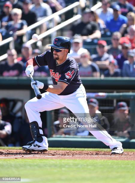 Lonnie Chisenhall of the Cleveland Indians attempts a bunt during the second inning of a spring training game against the Texas Rangers at Goodyear...