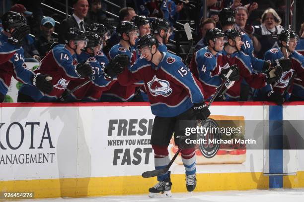 Duncan Siemens of the Colorado Avalanche celebrates his first career NHL goal against the Calgary Flames with teammates at the Pepsi Center on...