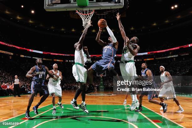 Gerald Wallace of the Charlotte Bobcats goes to the basket against Kevin Garnett and Kendrick Perkins of the Boston Celtics during the game on...