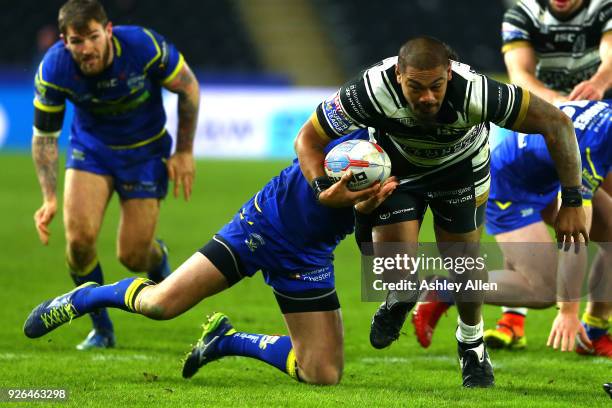 Sika Manu of Hull FC tackled by Matty Russell of Warrington Wolves during the BetFred Super League match between Hull FC and Warrington Wolves at...