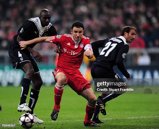 Mark Van Bommel of Bayern is challenged by Alou Diarra and Marc Planus of Bordeaux during the UEFA Champions League Group A match between FC Bayern...